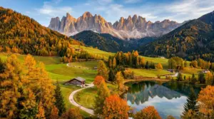 Paesaggio autunnale in Trentino con lago, boschi dai colori caldi e vette dolomitiche sullo sfondo